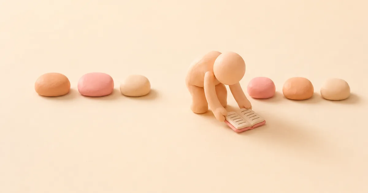 A small clay figure bending to pick an open notebook up off the floor, beside a row of clay pebbles with one gap in it